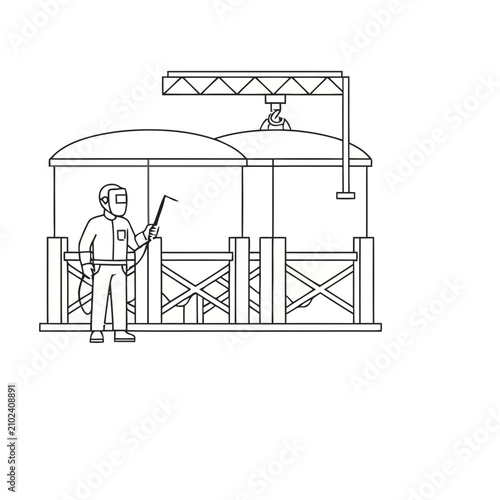 Welder working on industrial tanks