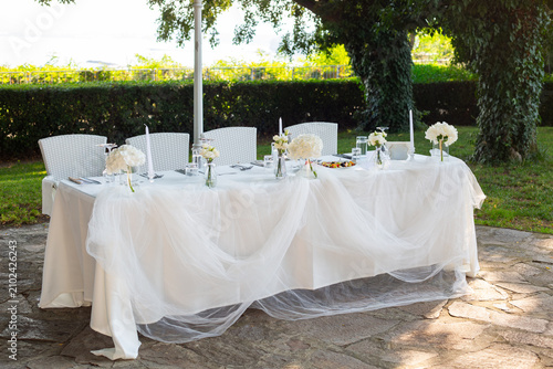 Obraz na plátně Elegant wedding reception table with white draped linens and floral centerpieces