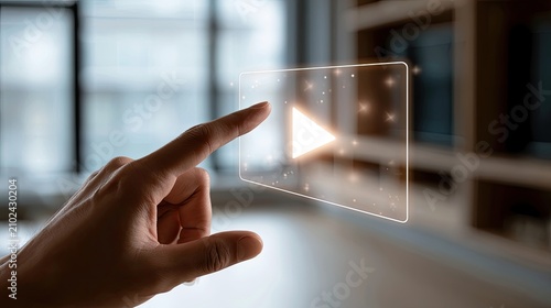 Hand presses illuminated play button on transparent digital interface