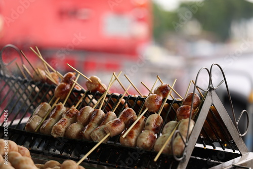 Bild auf Leinwand Grilled Thai Pork Sausages on Skewers at a Street Food Stall