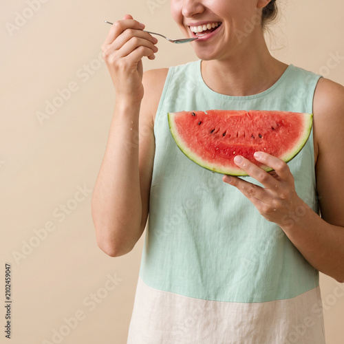 Woman eating fresh watermelon slice. Happy person enjoying healthy summer fruit snack.