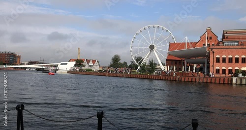 Gdansk Poland river ferris wheel historic district. Baltic coast northern Poland. World War II started with German invasion. Historical buildings, tourist attractions. Shipping transportation.