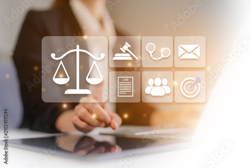 Legal technology and digital law concept with businesswoman selecting justice and legal services interface icons