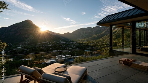 Luxurious modern balcony overlooking sun-drenched mountain valley with chaise lounges