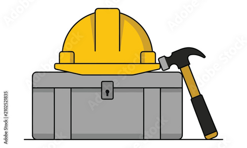 Labour day composition featuring yellow construction safety hard hat and steel tool box with hammer.