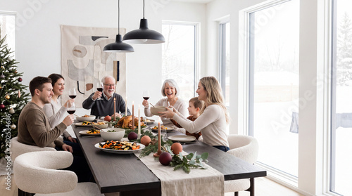 Multigenerational family sharing Christmas dinner at a beautifully set table in a bright modern dining room