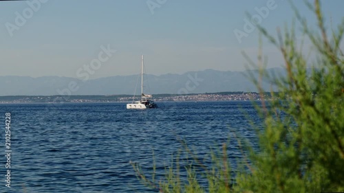 Catamaran on calm coastal blue sea