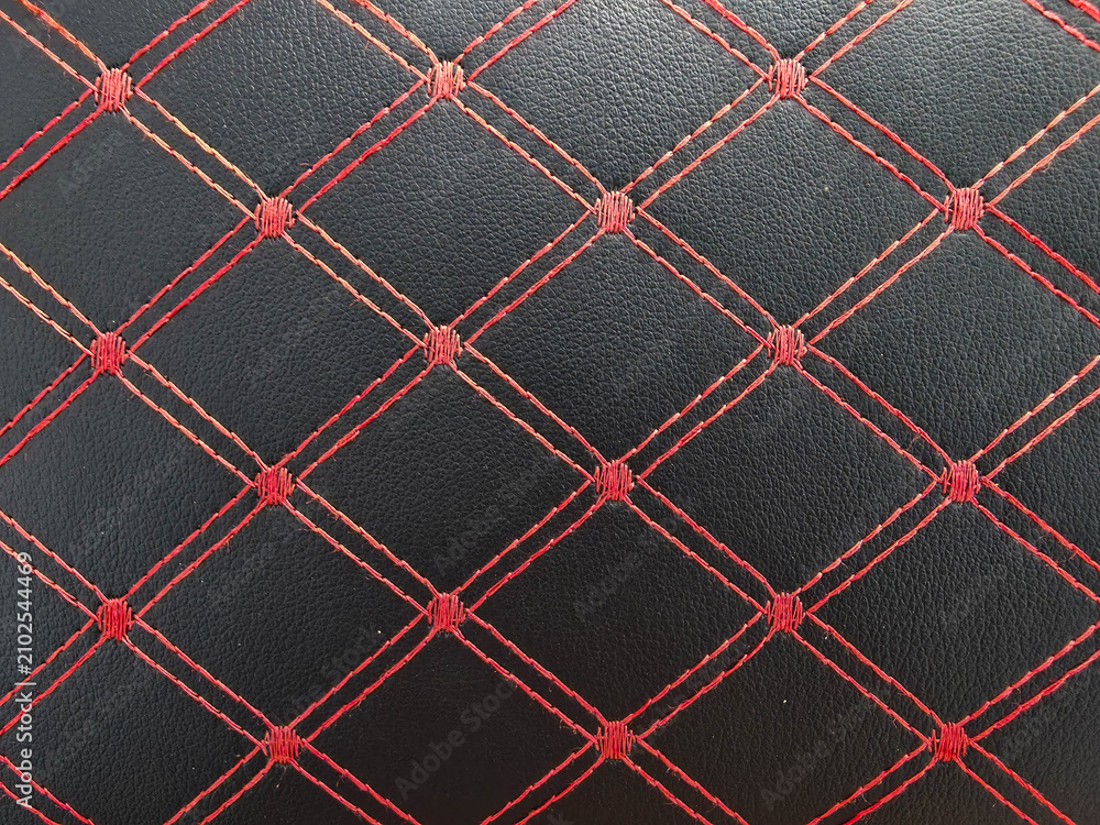 Obraz premium Black leather texture with red diamond stitching. Luxury car interior upholstery pattern.
