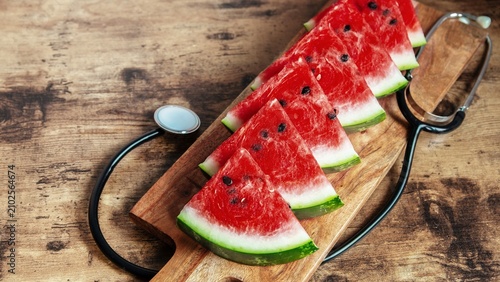 Canvastavla Watermelon slices and stethoscope on wooden board for heart health concept