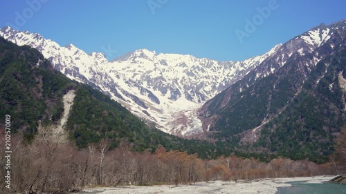 Snow covered mountain landscape with clear blue sky, nature and scenic wilderness.