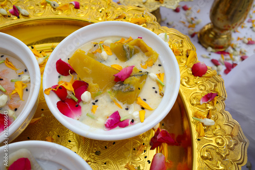 Thai traditional dessert pumpkin in coconut milk on a golden tray, as a ceremonial offering for worship rituals and sacred spirits. A traditional Thai dessert symbolizing blessings and good fortune.