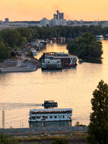 Passenger boats cruising on Sava River during Belgrade sunset