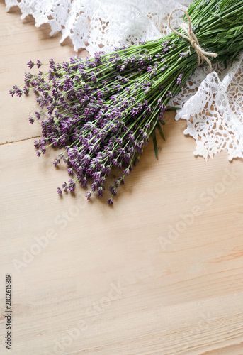 Lavender flowers lie on the table on lace