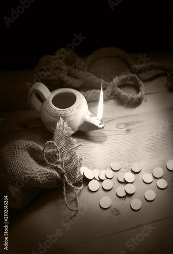 Canvas Print An oil lamp and silver coins