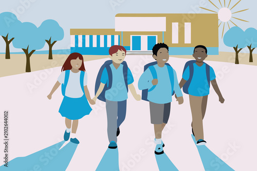 Group of children walking home from school together on a sunny day in a suburban area