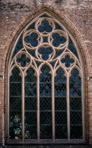 Tableau sur toile Intricate Gothic Tracery Window of a Historic Brick Building