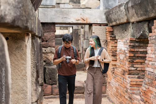 фотографія Young travelers explore ancient ruins with cameras