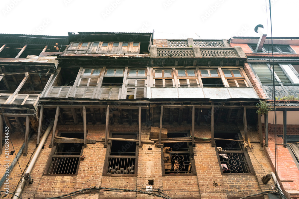 Fototapeta premium Centuries-old traditional Newari houses in Bhaktapur, Nepal, featuring beautifully preserved brick facades, carved wooden windows, and timeless architecture in one of the country's oldest city
