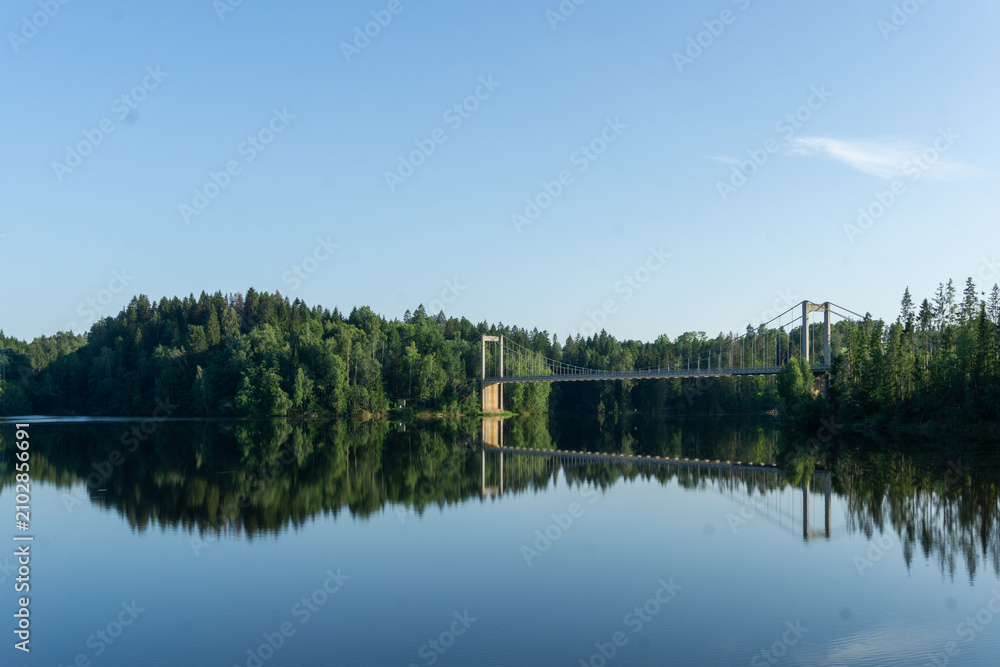 Obraz premium Vamma Bridge spanning Glomma river reflecting forest