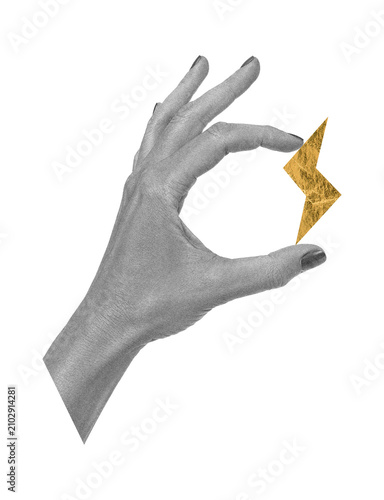 Surreal scrapbook art collage with human hand holding a golden foil lightning bolt on transparent background. Energy, power, creativity and bold ideas