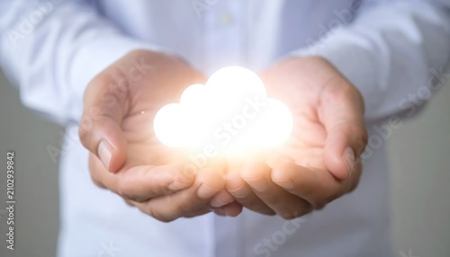 Person holding a glowing digital cloud between their hands.