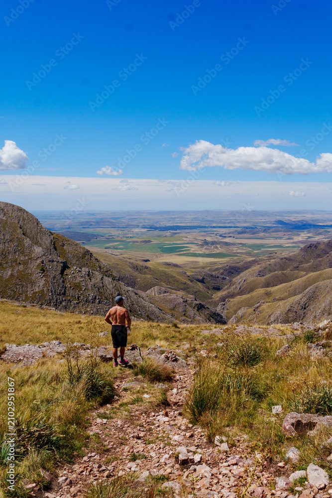Obraz premium Hiker overlooking a semiarid valley