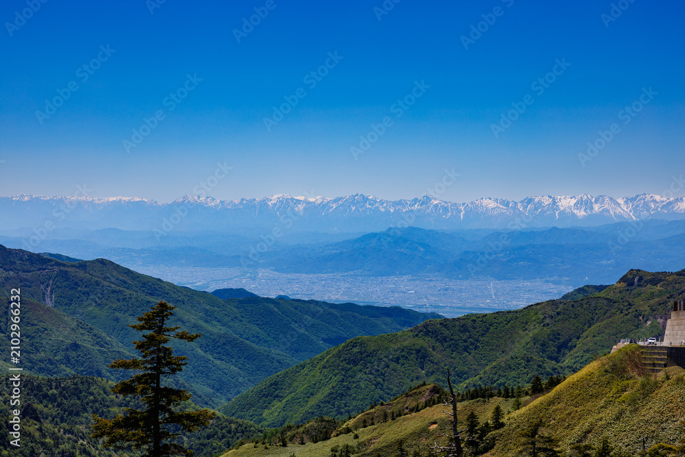 Obraz premium View overlooking Nagano City and the Northern Alps from Shiga Kogen.