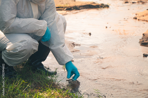 Environmental technician performing laboratory analysis of water samples to monitor pollution.