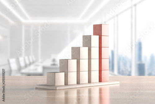 Quadro su tela Stacked wooden block histogram on modern office table for business performance a