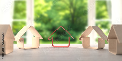Row of wooden house models with a red outline house in the center on a sunny windowsill for real estate banner background and property design