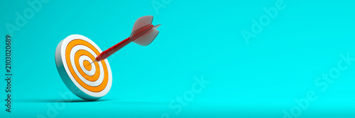 Single dart hitting center of circular target on turquoise background for banner header and advertising design with minimalist composition