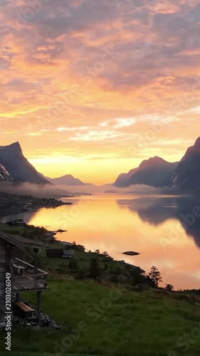 A Serene Sunset Over a Majestic Lake Surrounded by Mountains, Capturing the Tranquility of Nature in a Beautiful Landscape