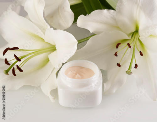 White Lilies and Cosmetic Cream Jar in Studio Setting
