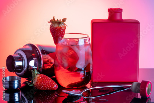 Vibrant Red Cocktail with Gin Bottle and Citrus Garnish