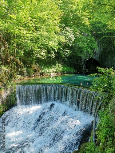 Krupajsko vrelo, Serbia - thermal water spring with healing properties. Wellhead of the Krupaja River, crystal-clear turquoise water, waterfall, cave, a famous tourist attraction hidden in the forest