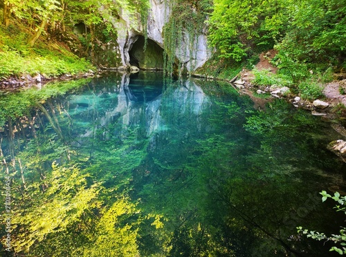 Krupajsko vrelo, Serbia - thermal water spring with healing properties. Wellhead of the Krupaja River, crystal-clear turquoise water, waterfall, cave, a famous tourist attraction hidden in the forest