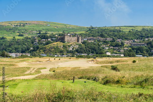 фотографія General view of the small town of Harlech and golf course in west Wales