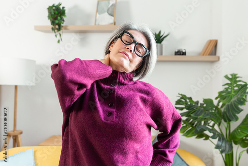Senior woman stretching at home for daily wellness routine