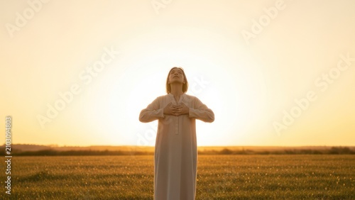 Woman Meditating in Field at Golden Sunset