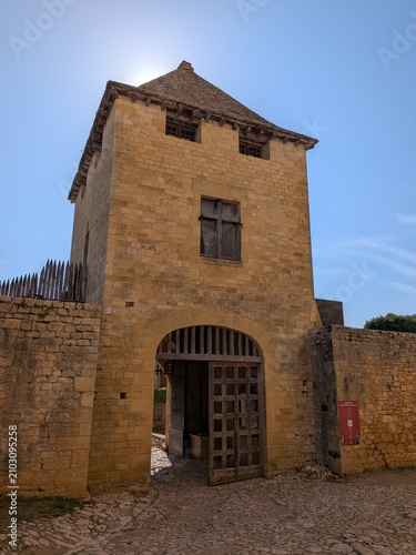 фотографія Medieval stone gatehouse tower with an open wooden portcullis gate at Château de