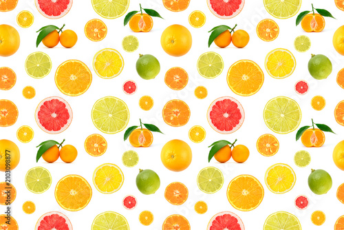 Repeating seamless pattern of mixed citrus fruits whole oranges lemons limes pink grapefruits and slices with leaves arranged on white background