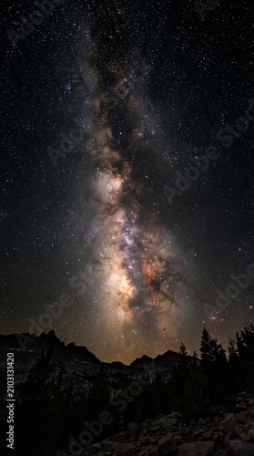The brilliant Milky Way arc above dark mountains.