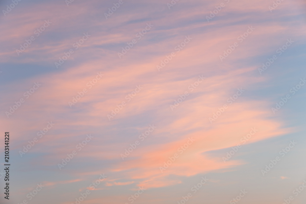 Fototapeta premium Soft sky background with pastel-colored clouds running at a slight angle, at sunset