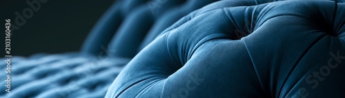 Elegant blue tufted sofa close-up detail.