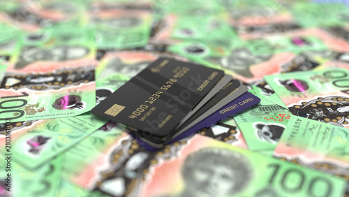 Obraz na płótnie Black credit cards placed on top of australian dollar banknotes.