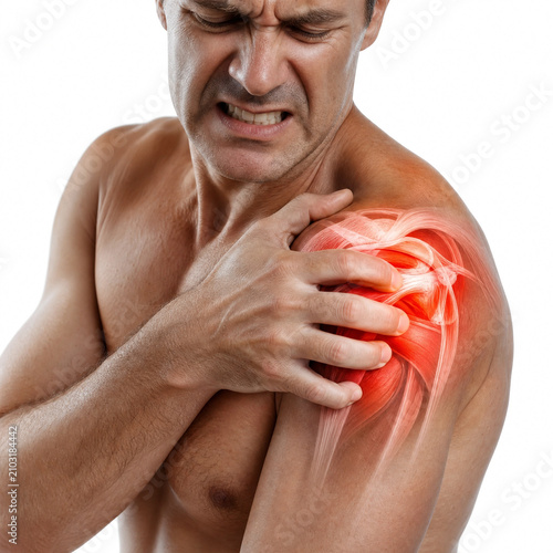 Distressed man suffering from severe shoulder pain holding his injured inflamed muscle with visible agony