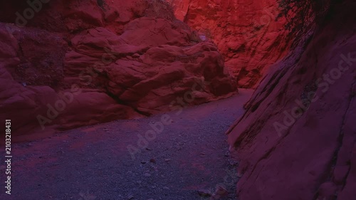 Drone low aerial pass beside sculpted red rock walls at Quebrada de las Señoritas in Jujuy, Argentina