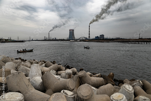 Принти на полотні A coastal power plant stands beside the sea and backwaters during the early morning, reflecting the balance between energy production and environmental stewardship