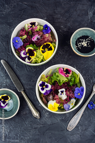 Vegetarian gourmet salad with edible flowers and fresh greens.