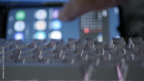 Blurred Shooting with a Person sliding on mobile screen, Typing on Keyboard, Writes in a Social Media App. Computer Programmer Accesing Social Media Network.